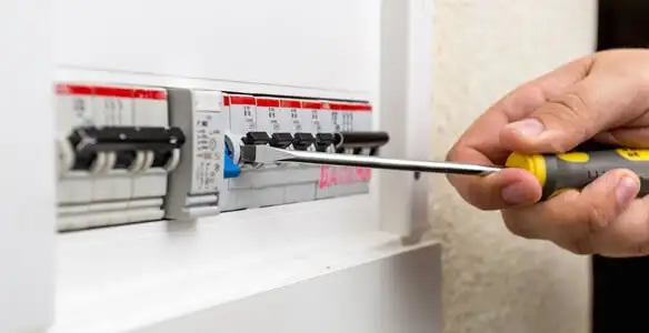electrical panel upgrade service showing technician adjusting circuit breakers during system upgrade in Littleton, CO