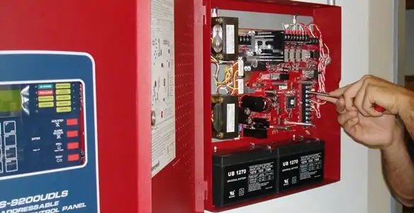 fire alarm installation service showing technician configuring fire alarm control panel in Littleton, CO