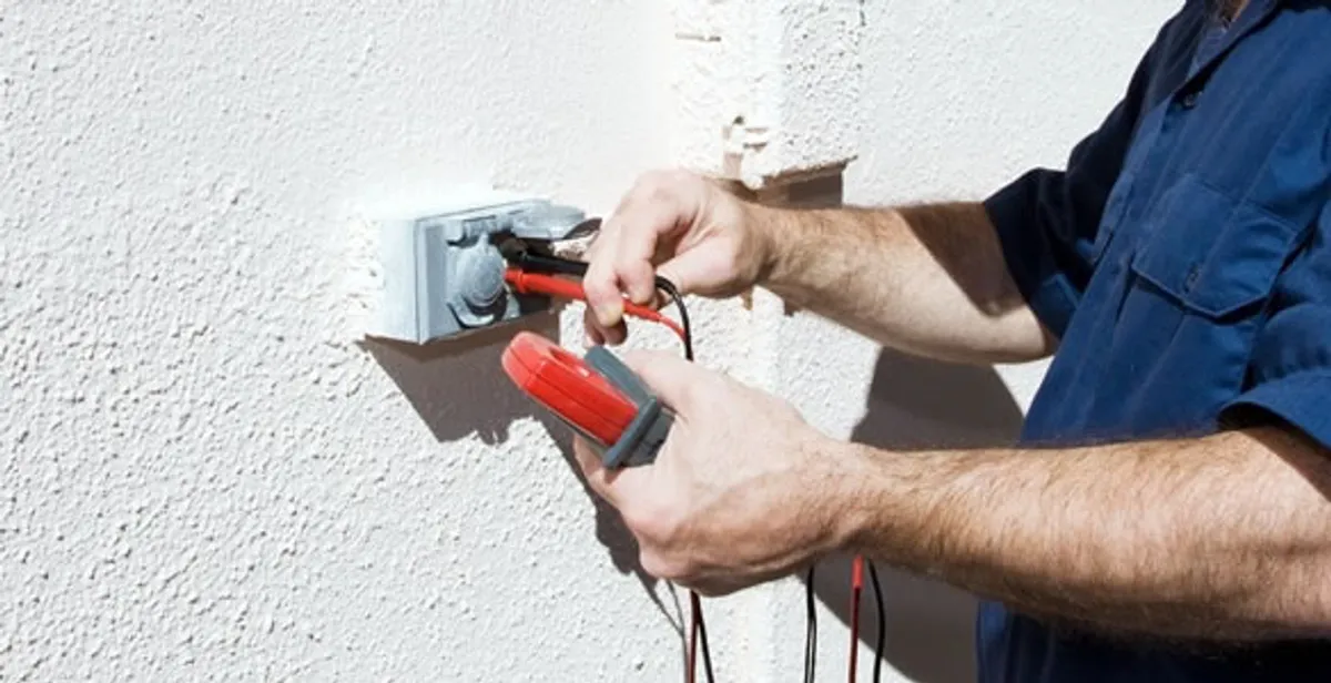 Electrician performing home electrical outlet and wiring inspection in Littleton, CO