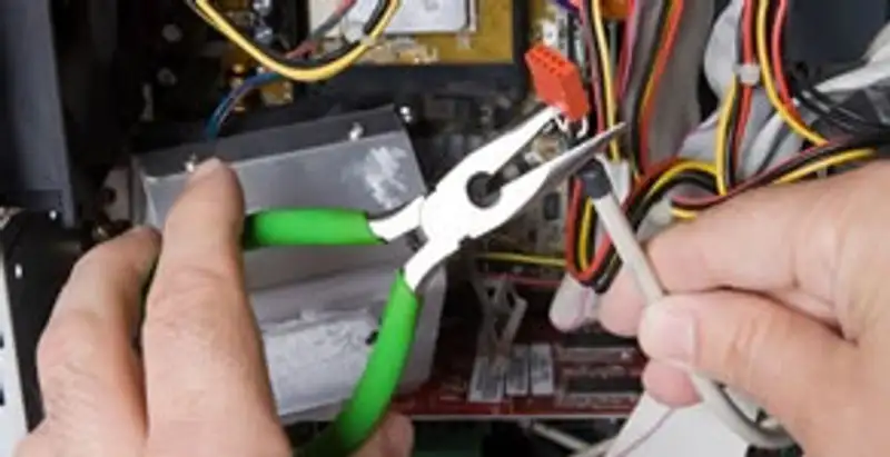 Licensed electrical contractor performing electrical repair with tools in Morrison, CO